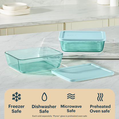 Two glass food containers with lids on a kitchen counter, featuring icons and text about safety.