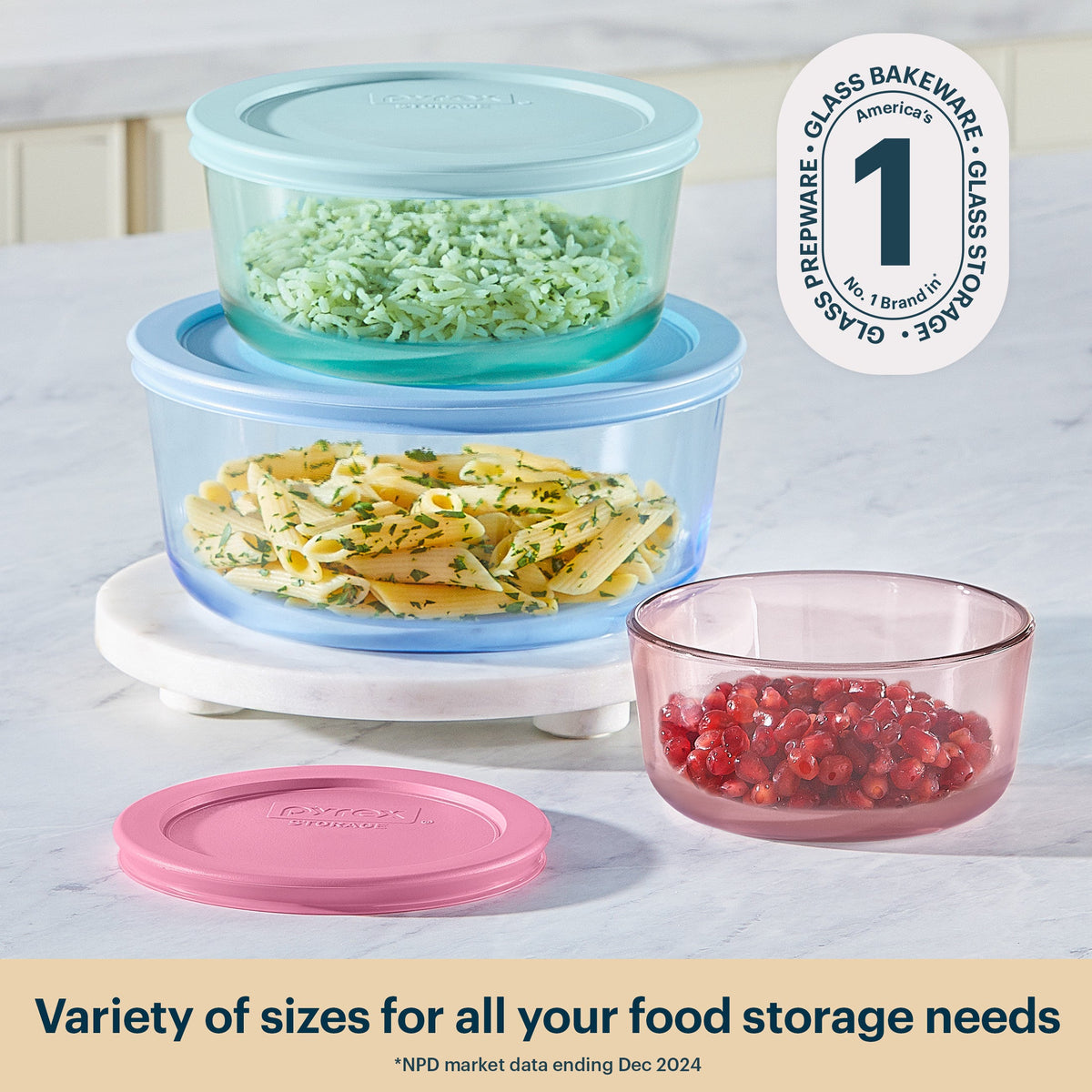 Set of glass food storage containers with lids on a countertop.