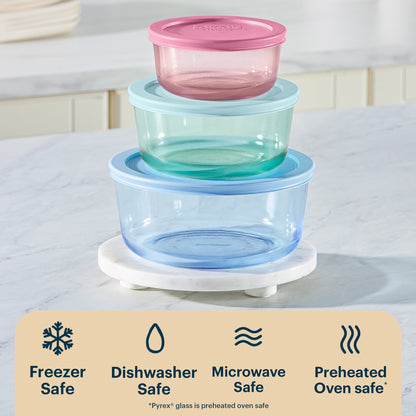 Stack of colorful glass food containers with a white background