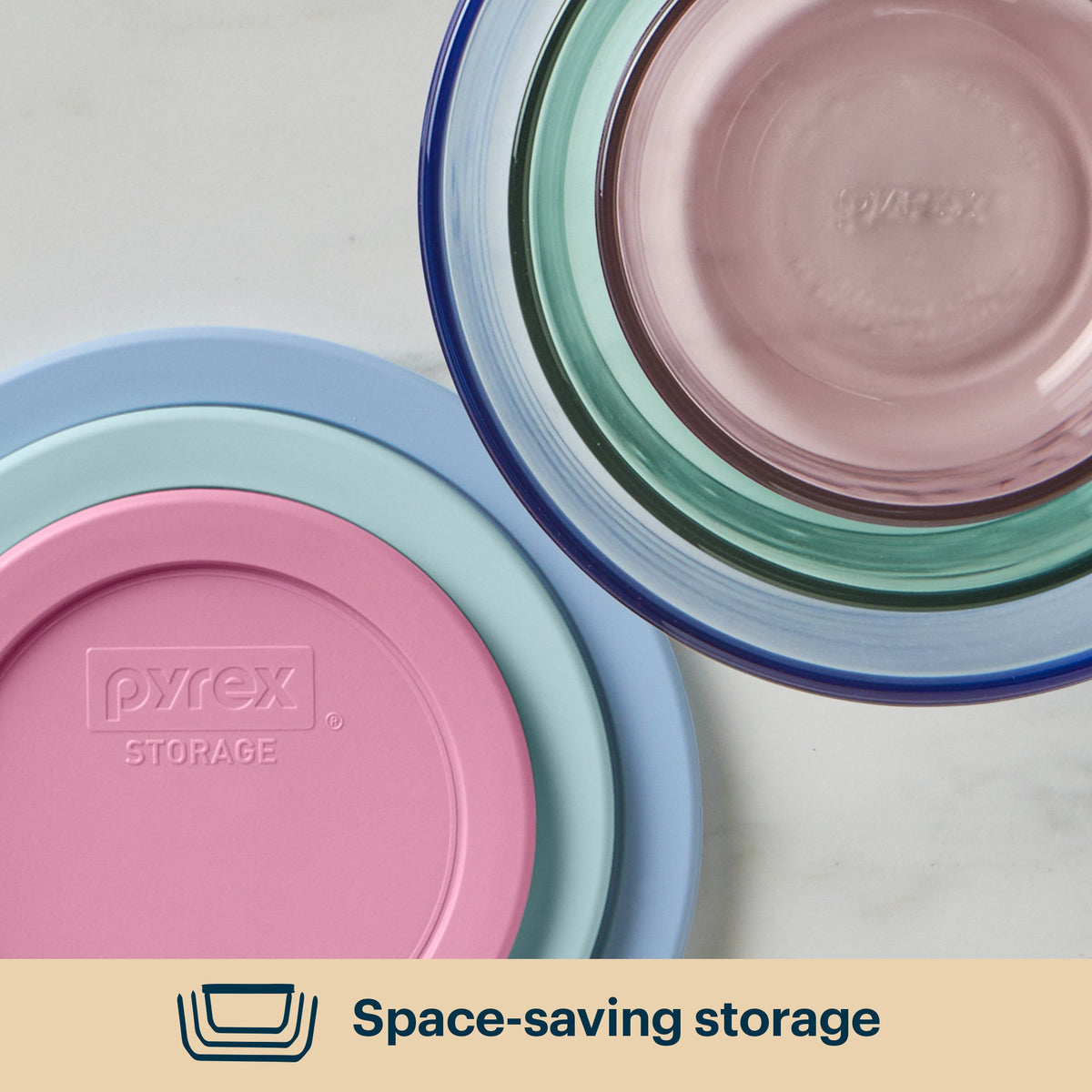 Stack of Pyrex storage bowls in pastel colors on a light background