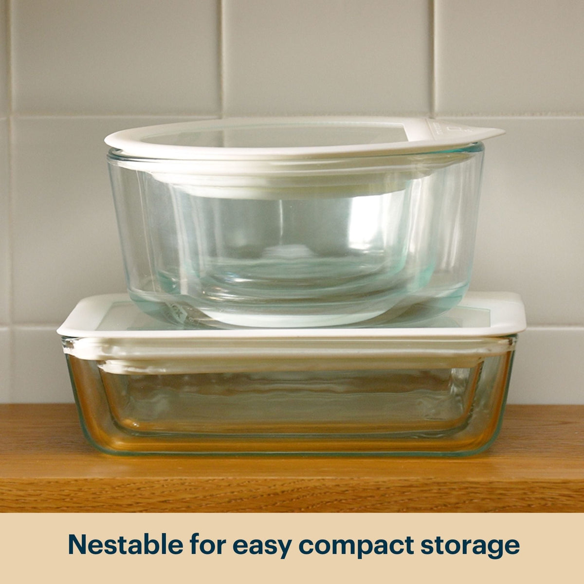 Stacked Pyrex glass storage containers with clear lids.